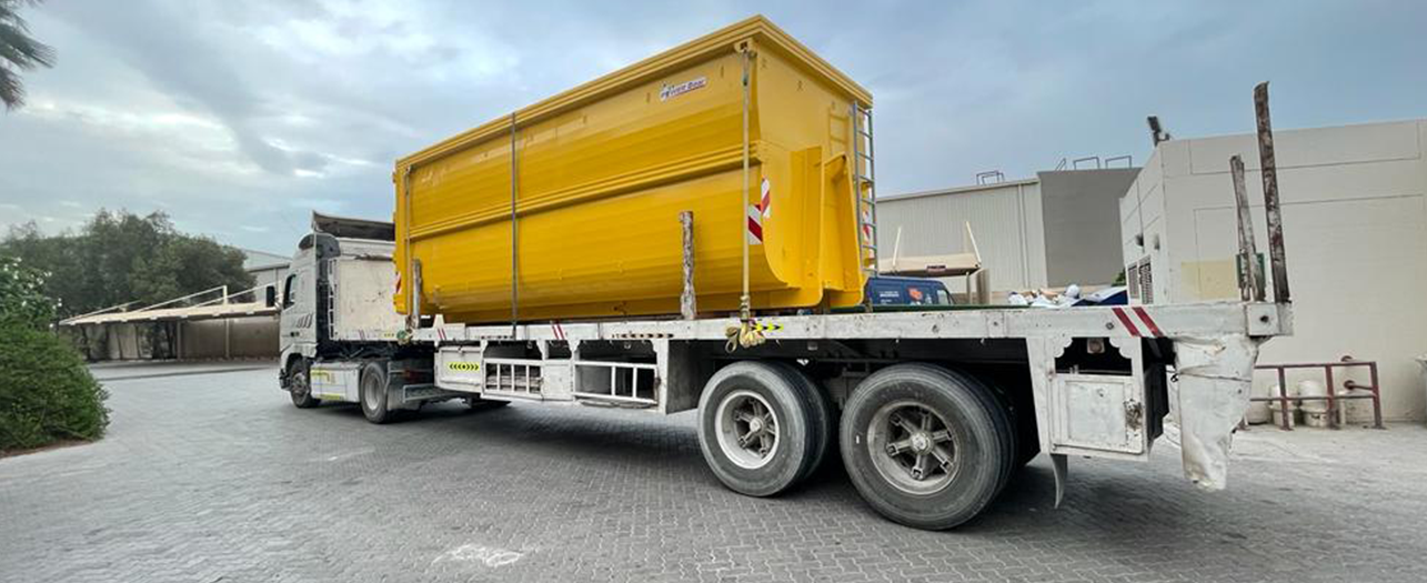 Yellow waste container loaded on truck